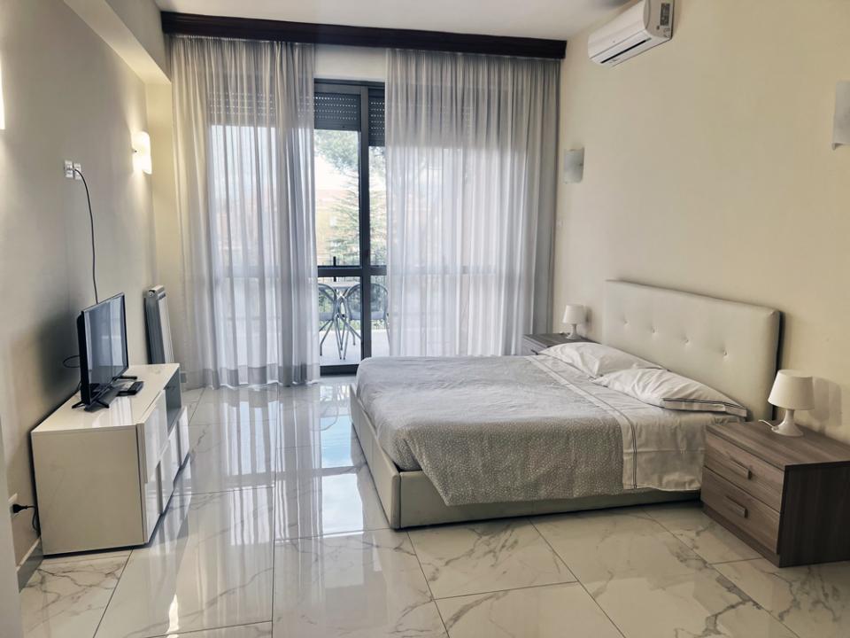 Modern, bright, cozy room with a double bed and balcony view.